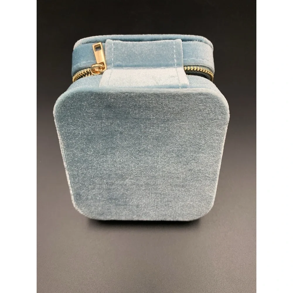 Small blue velvet jewelry box with a zipper